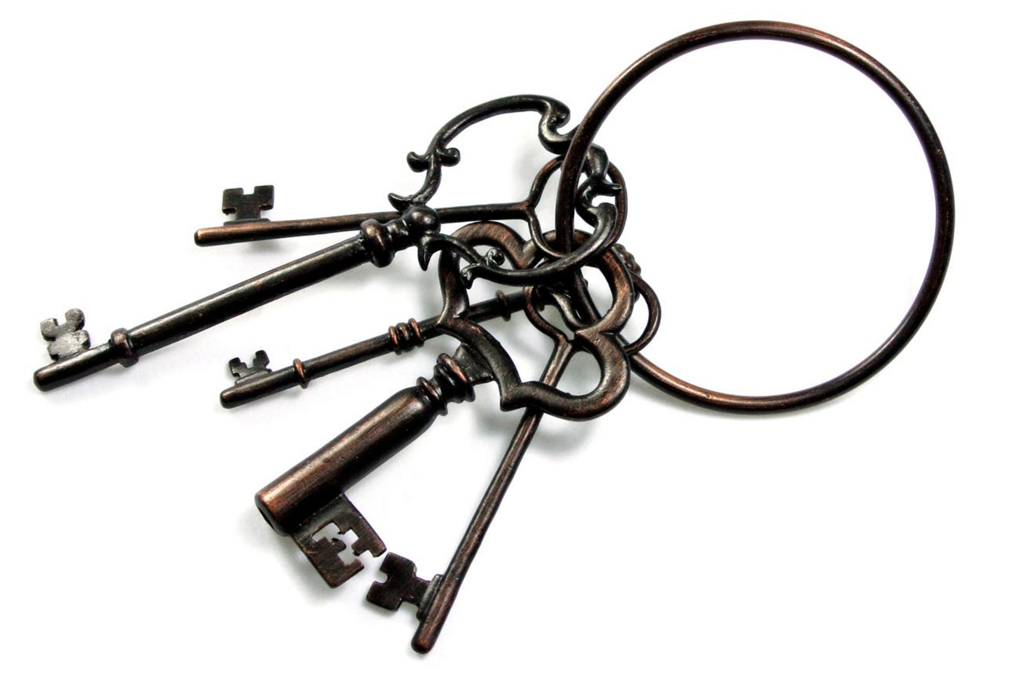 An old, large keyring with five old, large keys.