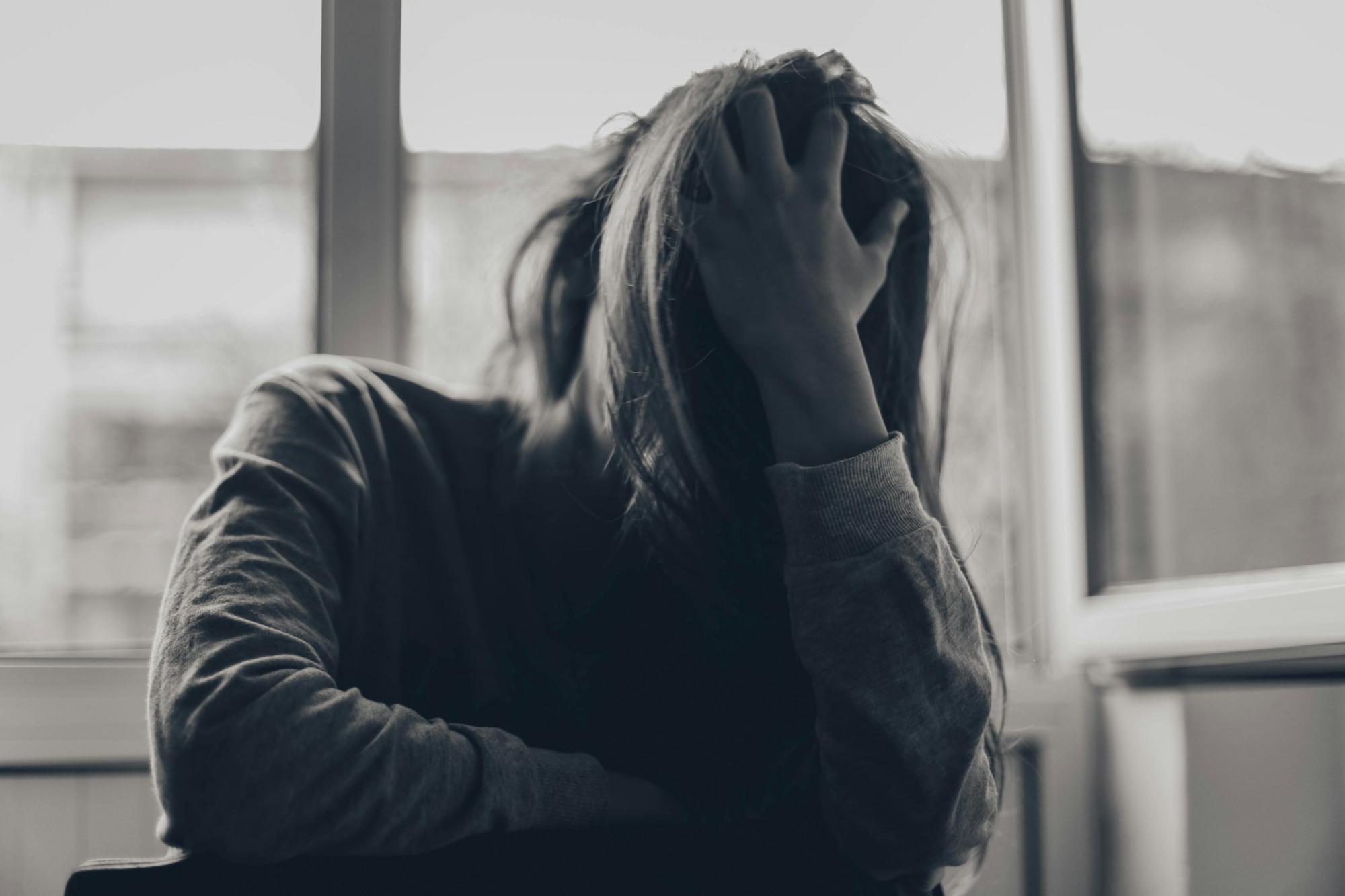 Woman holding her head in her hands